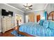 Large main bedroom featuring hardwood floors, walk-in closet, ceiling fan, and access to the outdoor area at 14739 Vista View Ct, Dade City, FL 33523