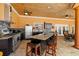 Covered outdoor kitchen area with a stainless steel range, island with barstools, and ceiling fans at 14739 Vista View Ct, Dade City, FL 33523
