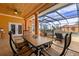 Spacious outdoor patio featuring a dining area, screened-in pool, and beautiful wooden ceilings at 14739 Vista View Ct, Dade City, FL 33523