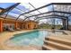 Sparkling screened pool with a spa and ample seating, perfect for relaxation and outdoor enjoyment at 14739 Vista View Ct, Dade City, FL 33523