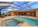 Inviting screened pool with a spa, providing a luxurious outdoor living experience at 14739 Vista View Ct, Dade City, FL 33523
