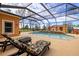 Inviting screened pool and spa with lounge chairs, creating an ideal outdoor retreat at 14739 Vista View Ct, Dade City, FL 33523