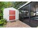 A backyard shed and screened-in patio offer storage and outdoor living space at 1560 Bel Keene Dr, Clearwater, FL 33756
