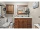 Cozy bathroom featuring wood cabinets, a neutral paint color, and a large mirror at 1560 Bel Keene Dr, Clearwater, FL 33756