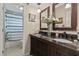Bathroom featuring double sinks, dark cabinetry, and a tub at 1560 Bel Keene Dr, Clearwater, FL 33756