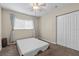 Bedroom with a ceiling fan, large window, and a mattress on the floor at 1560 Bel Keene Dr, Clearwater, FL 33756