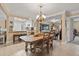 Elegant dining area with a wooden table, stylish chandelier, and open layout at 1560 Bel Keene Dr, Clearwater, FL 33756