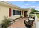 Inviting front porch with brick pavers, comfortable seating, and decorative plants at 1560 Bel Keene Dr, Clearwater, FL 33756