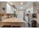Modern kitchen with granite countertops, stainless steel appliances, and wood-look floors at 1560 Bel Keene Dr, Clearwater, FL 33756