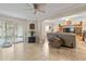 Open living room showcasing tile flooring, a ceiling fan, and a sliding glass door at 1560 Bel Keene Dr, Clearwater, FL 33756