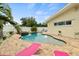 Backyard pool featuring stone patio and lounge chairs at 1560 Bel Keene Dr, Clearwater, FL 33756