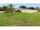 Landscaped yard with mature palm tree and a privacy fence that surrounds the property at 1560 Bel Keene Dr, Clearwater, FL 33756