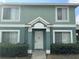 Two-story townhome with light green exterior and landscaping at 1621 Fluorshire Dr, Brandon, FL 33511
