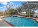 Beautiful in-ground pool with a screened enclosure, providing a private oasis at 1746 Golden Dawn Pl, Wesley Chapel, FL 33543