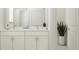 Elegant bathroom with double vanity and marble countertops at 18429 Serene Lake Loop, Lutz, FL 33548