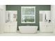 Elegant bathroom with a freestanding tub and double vanities at 18429 Serene Lake Loop, Lutz, FL 33548