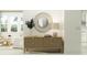 Entryway showcasing a stylish woven wood console table and a large circular mirror at 18429 Serene Lake Loop, Lutz, FL 33548