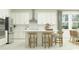 Modern kitchen with island, white cabinets, and stainless steel appliances at 18429 Serene Lake Loop, Lutz, FL 33548