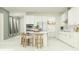 Modern white kitchen with island, stainless steel appliances, and ample cabinet space at 18429 Serene Lake Loop, Lutz, FL 33548
