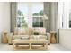 Living room with beige sofa and wooden coffee table, offering natural light at 18429 Serene Lake Loop, Lutz, FL 33548
