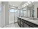 Bright bathroom with dual sinks, granite counters, and a glass-enclosed tiled shower at 1896 Tallulah Ter, Wesley Chapel, FL 33543