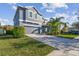 Two-story home showcasing a gray exterior, attached garage and well manicured front lawn at 1896 Tallulah Ter, Wesley Chapel, FL 33543