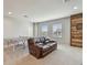 Well-lit game room featuring a ping pong table, a leather sofa, and a rustic wood accent wall with a dartboard at 1896 Tallulah Ter, Wesley Chapel, FL 33543