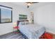 This modern bedroom features wood floors, a ceiling fan and views of the ocean at 1972 Dolphin S Blvd, St Petersburg, FL 33707