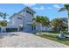 Modern two-story home with a well-manicured lawn and beautiful palm trees at 1972 Dolphin S Blvd, St Petersburg, FL 33707