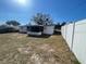 Fenced backyard featuring a covered patio with a lawn at 2036 Melody Dr, Holiday, FL 34691