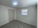 Bedroom featuring wood-look flooring, window with blinds and closet at 2036 Melody Dr, Holiday, FL 34691