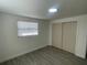 Bedroom with wood-look flooring, window with blinds and closet at 2036 Melody Dr, Holiday, FL 34691