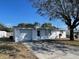 Inviting single-story home with a spacious driveway and well-kept landscaping at 2036 Melody Dr, Holiday, FL 34691