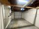 Unfinished garage with overhead door and visible rafters at 2036 Melody Dr, Holiday, FL 34691