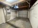 Unfinished garage with overhead door and visible rafters at 2036 Melody Dr, Holiday, FL 34691