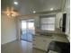 Bright kitchen with white cabinets and a view of the outdoor patio at 2036 Melody Dr, Holiday, FL 34691