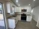 Modern kitchen featuring stainless steel appliances and granite countertops at 2036 Melody Dr, Holiday, FL 34691