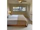 Comfortable bedroom with a large window, ceiling fan, and built in closet at 2051 High Ridge Dr, Clearwater, FL 33763
