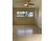 Bright bedroom featuring a ceiling fan, tile floor, and a large window with a pleasant view at 2051 High Ridge Dr, Clearwater, FL 33763
