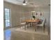 Well-lit dining room features a modern chandelier and a wood table with seating for six at 2051 High Ridge Dr, Clearwater, FL 33763