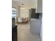 Eat-in kitchen and dining area featuring modern light fixture, stainless steel appliances and tile floors at 2051 High Ridge Dr, Clearwater, FL 33763