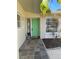Attractive front entrance with a green door, tiled floor, and decorative security screen at 2051 High Ridge Dr, Clearwater, FL 33763