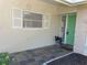 Well-lit front entrance featuring a bright green door and tiled entryway at 2051 High Ridge Dr, Clearwater, FL 33763