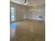 An empty room featuring tile flooring, a modern ceiling fan and decorative lighting fixture at 2051 High Ridge Dr, Clearwater, FL 33763