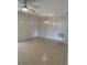 An empty room featuring tile flooring, a modern ceiling fan and decorative lighting fixture at 2051 High Ridge Dr, Clearwater, FL 33763