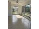 Inviting sun room with tiled floors and lots of natural light from the large windows at 2051 High Ridge Dr, Clearwater, FL 33763