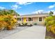 Inviting home exterior featuring a yellow door, well-maintained landscaping, and fresh paint at 2326 44Th S St, St Petersburg, FL 33711