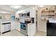 Modern kitchen featuring stainless steel appliances, white cabinetry, and open shelving at 2326 44Th S St, St Petersburg, FL 33711