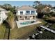 Aerial view of a home with backyard pool and fence at 244 S Beach Dr, Tarpon Springs, FL 34689