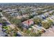 Aerial view of a single-story house with a brown roof and well-maintained landscaping in a community at 2589 Northfield Ln, Clearwater, FL 33761